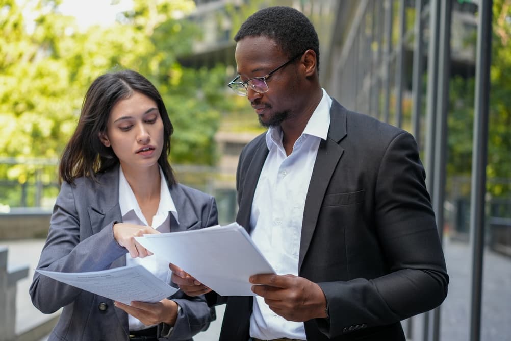 DAX Solutions Corp consultants reviewing program documents